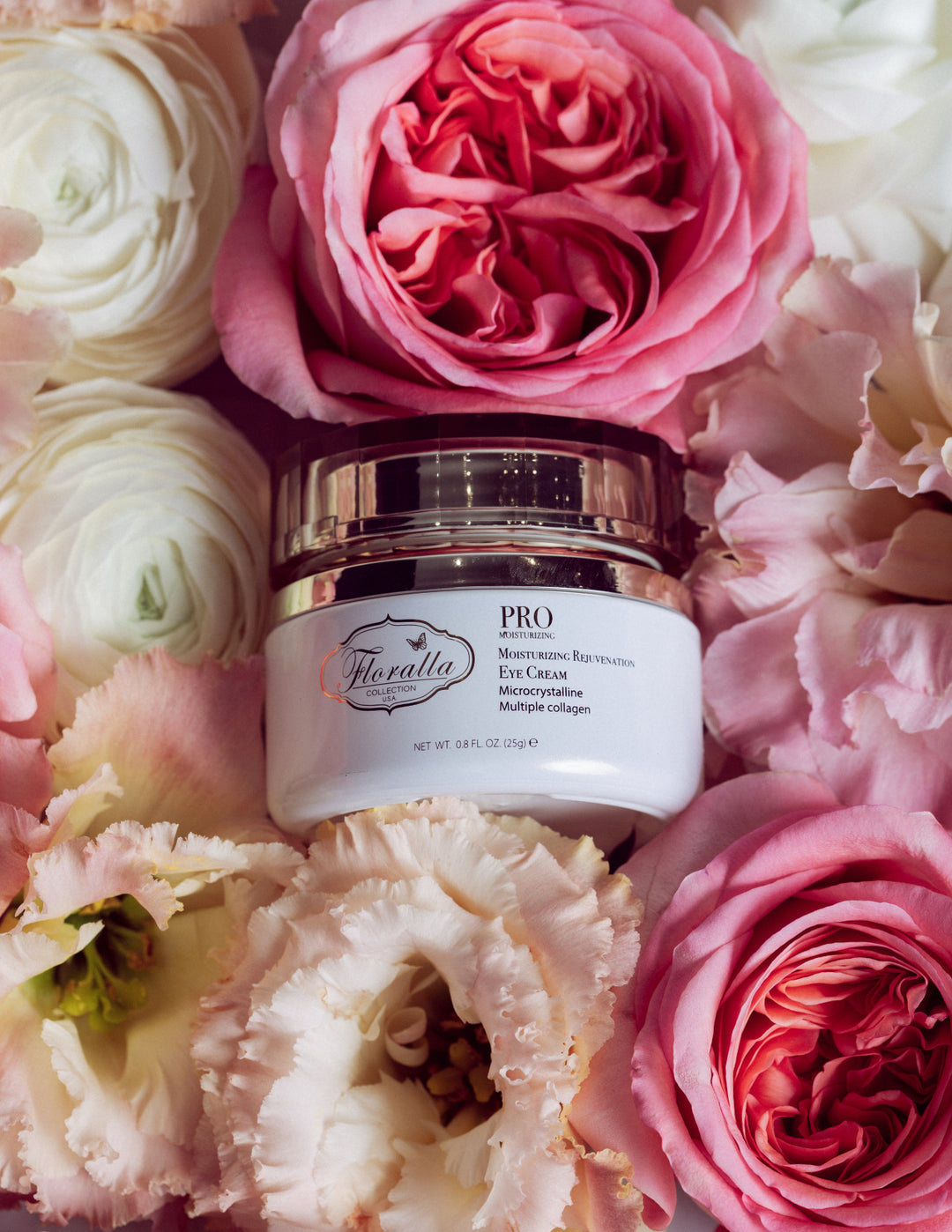 Floralla PRO Moisturizing Rejuvenation Eye Cream jar with microcrystalline and collagen formula, displayed among pink, white, and peach flowers, representing luxury skincare for anti-aging and hydration.