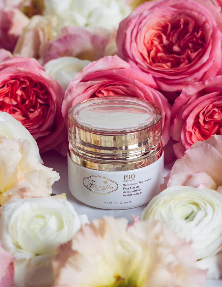 Floralla Pro Moisturizing Rejuvenating Face Cream in a gold-rimmed jar, surrounded by pink and white roses.