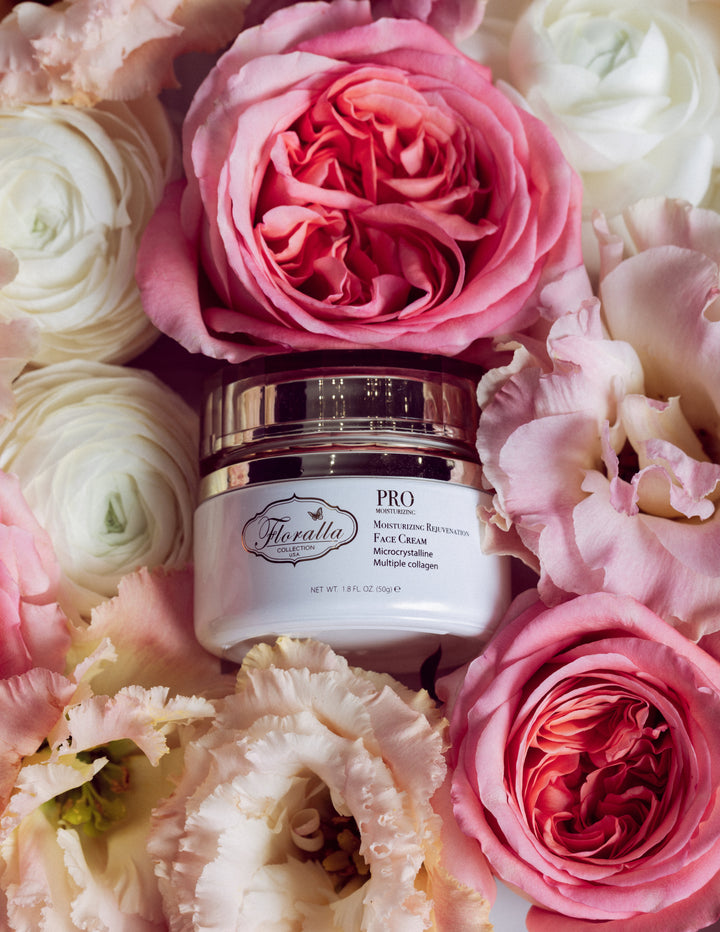 Floralla Pro Moisturizing Rejuvenating Face Cream in a gold-rimmed jar, surrounded by pink and white roses.